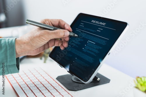 Reviewing digital resume on tablet with pen