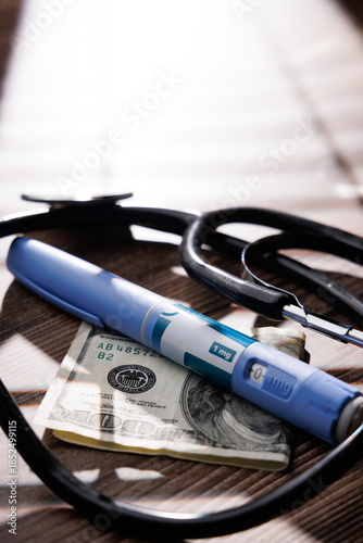 Close up of semaglutide GLP-1 pens with a stethoscope and a 100 dollar bill on a dark wood surface for healthcare and finance themes