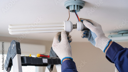 electrician at work, Installing new part, Typical industrial work, Following safety rules, Handling electrical parts,  Gloves protect hands, Performing routine maintenance, Safety is first