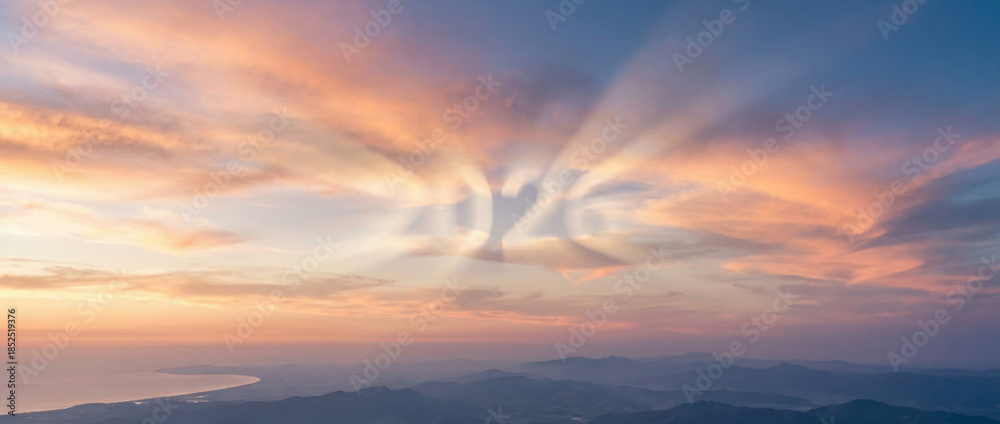 Fototapeta premium Beautiful Sunset Sky with 2026 Glowing in Sun Rays over Distant Hazy Landscape