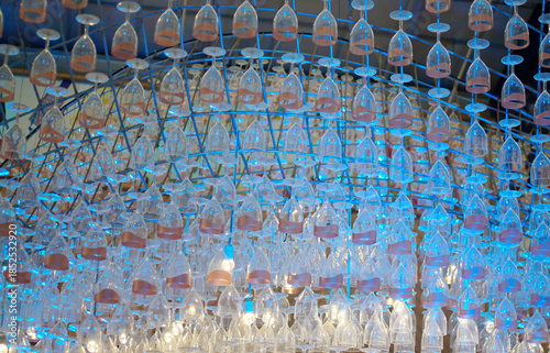 Ceiling decoration, Wine glass hang with structure and blue color lighting decorate ceiling at mall
