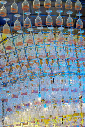 Ceiling decoration, Wine glass hang with structure and blue color lighting decorate ceiling at mall