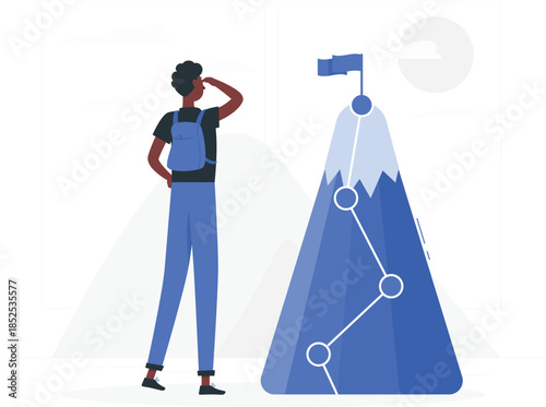 Man in blue overalls looking at mountain with flag and path