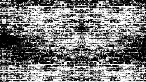 a stark black and white brick wall with a rough texture, creating a high contrast and abstract background