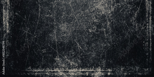 A heavily distressed and aged black and white texture featuring scratches grain and a worn appearance creating a vintage effect