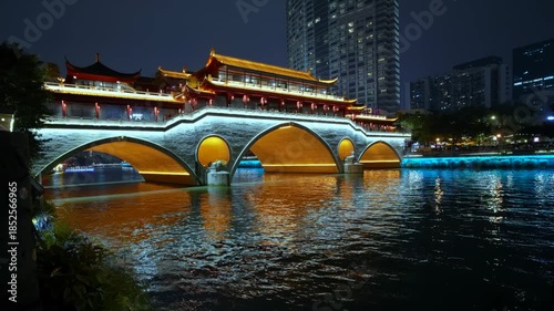 Beautifully illuminated anshun bridge reflecting in the jin river at night in chengdu, sichuan