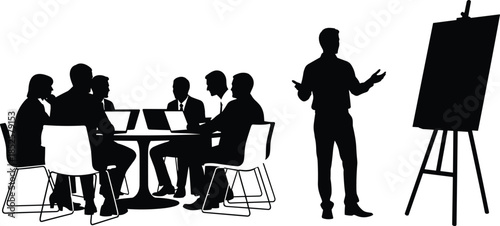 Silhouette of a business strategy meeting with a corporate team working on laptops and a speaker presenting with an easel.