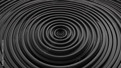 Abstract dark grey concentric ripples creating a hypnotic visual effect.