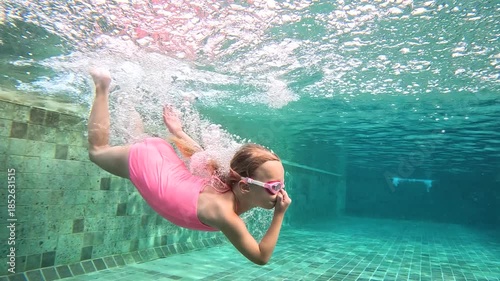 Underwater swimming session of a child in a pool setting