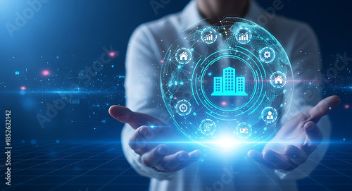 Person holding a glowing digital sphere representing a smart building network in their hands technology