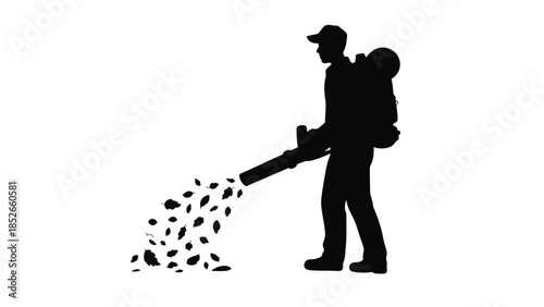Man using leaf blower outdoors in silhouette