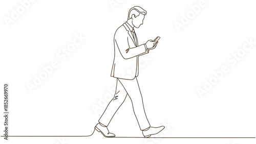 Focused businessman walking while looking at his mobile phone, engaged with technology.