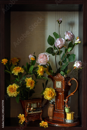 Still life with small bouquets of flowers in ceramic milk jugs.