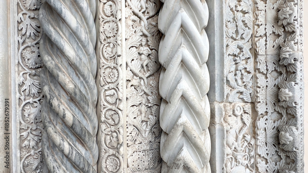 Naklejka premium Ornate italian romanesque marble carving with twisted column details