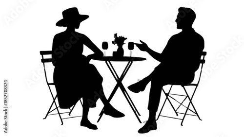 Two friends enjoying a conversation with drinks at a bistro table.