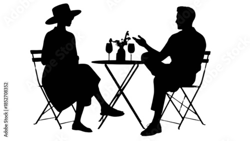 Two people enjoying a conversation at an outdoor cafe table with drinks and flowers.