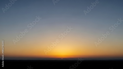 Serene sunrise over calm waters with vibrant colors and gentle clouds