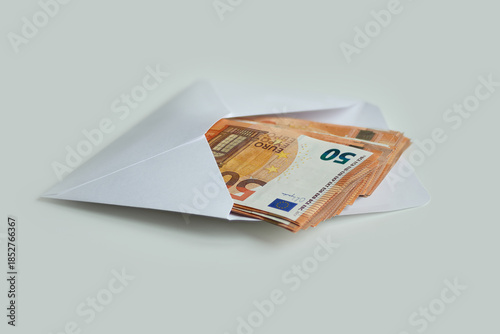 Bundles of banknotes of 50 euros lying in the envelope as a sign of a gift , isolated