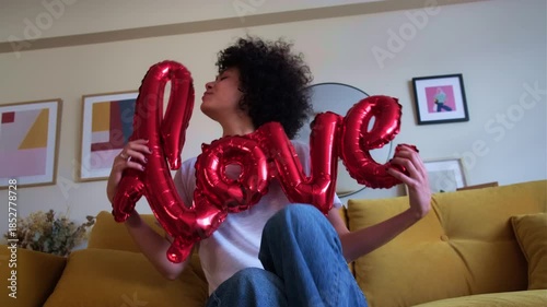 Happy woman celebrating valentine's day with love balloon