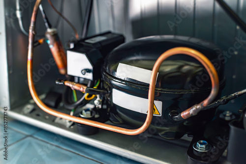 Refrigerator compressor with copper tubing inside appliance, cooling system technology for refrigeration, repair, maintenance and engineering concepts
