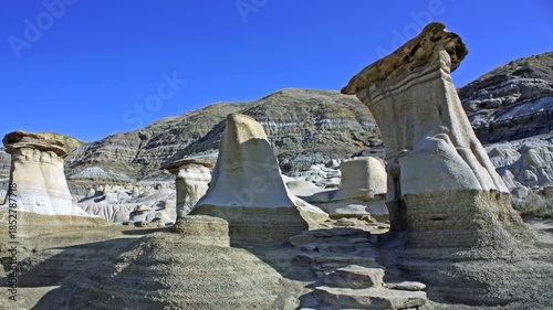 Hoodoos near Drumheller, Alberta, Canada .A hoodoo is a tall, thin spire of  sedimentary rock and volcanic rock formed by erosion . 
