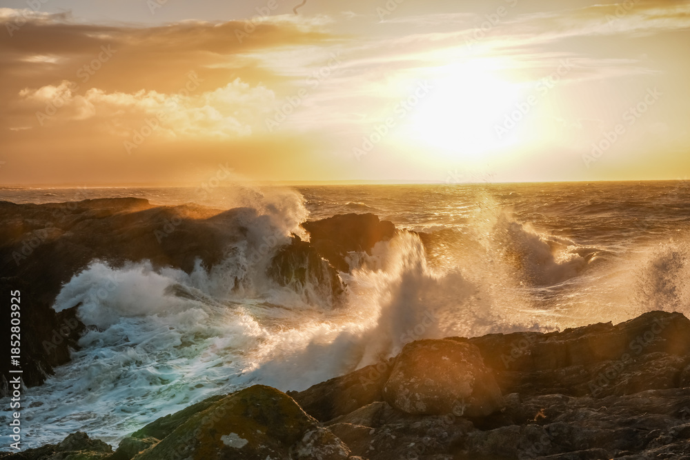 Obraz premium Sunrise at Rhoscolyn with rough seas Anglesey North wales