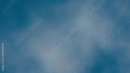 Seamless loop background with realistic flying through sparse white clouds in a deep blue sky. Abstract aerial mist animation with calm atmosphere and smoothly moving camera effect. Looped 4K 60fps