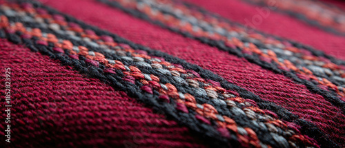 Woven fabric textile pattern red black gray stripe closeup texture handcrafted detail with cozy mood