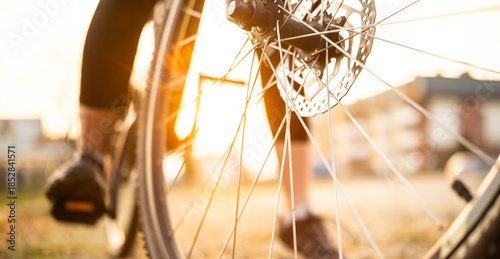 Female Foot On Bicycle Pedals At Autumn Sunset