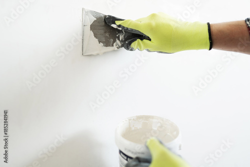 Vászonkép Worker Applies Wall Putty With A Spatula For Wall Preparation Before Painting