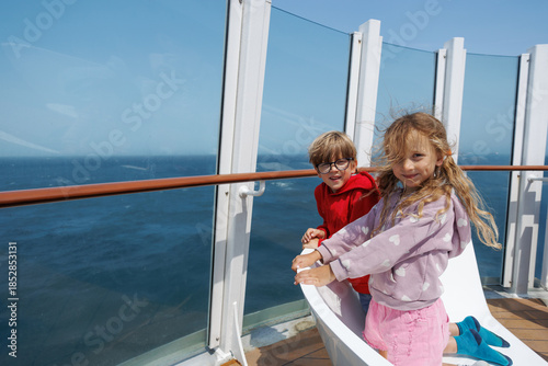 Billede på lærred Smiling children explore the cruise ship aboard an adventure