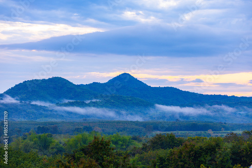 A photograph of the morning sky. Sunrise. Mountain landscape with mist surrounding the mountains.