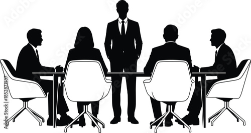 Silhouette of a male leader standing at a conference table during a professional business meeting with a diverse corporate team.