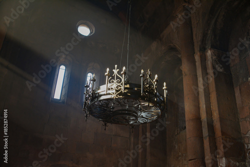 Monastery interior. An old lamp in the church. Sunlight streaming through the windows. Christianity and religion.