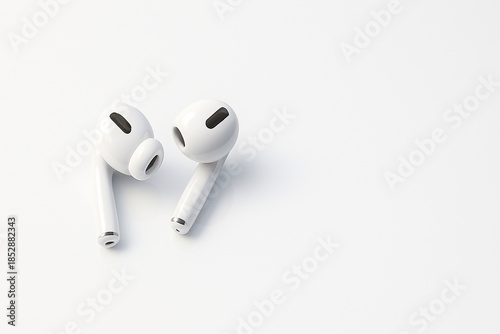 White wireless earbuds under clinical neutral light on glossy acrylic background.