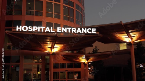 Hospital Entrance with Signage. Emergency Sign at Hospital in USA. Emergency Room and Medical Care Building. Hospital, Medical Center, Emergency Room. Evening Night Times.
