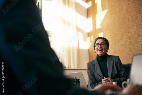 Happy female financial advisor communicating in meeting at law firm