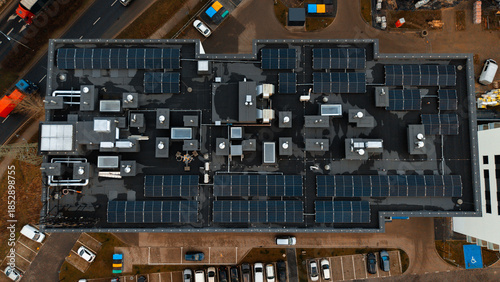 Obraz na płótnie Aerial top-down view of industrial building rooftop with solar panels and HVAC s