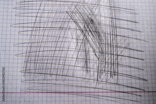 Cross strokes of graphite pencil in notebook