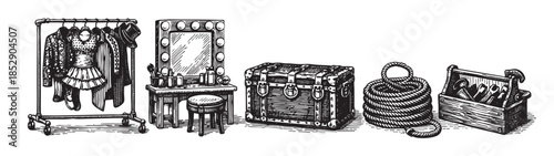 A vintage black and white illustration depicts a theatrical dressing room scene with costumes on a rack, a vanity mirror, a trunk, rope, and a toolbox.