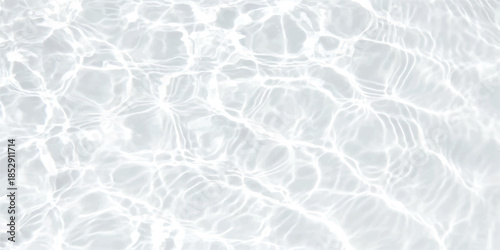 Bright abstract pattern of sunlight shimmering on the surface of crystal clear water