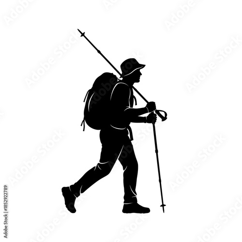 Silhouette of a male hiker with a backpack and trekking poles walking on an adventure trip.