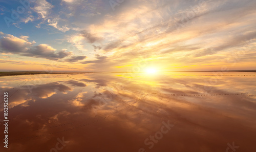 Vibrant sunrise over mirror-like reflective lake