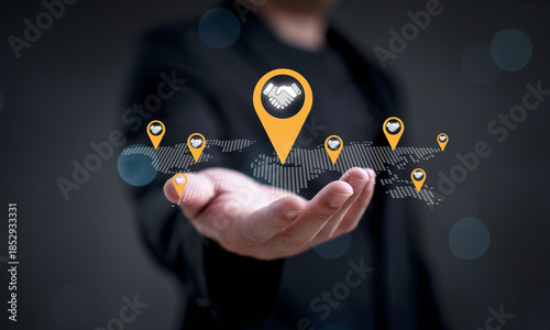 Slika na platnu Business partnership concept showing global deal and agreement with handshake icons on world map for symbol of international collaboration, corporate networking, strategic alliance trust and success