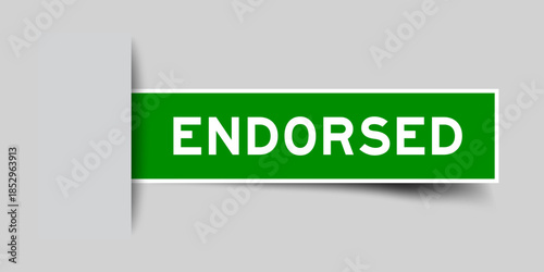 Green color square shape sticker label with word endorsed inserted in gray background