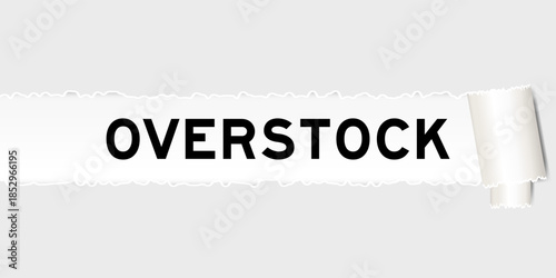 Ripped gray paper background that have word overstock under torn part