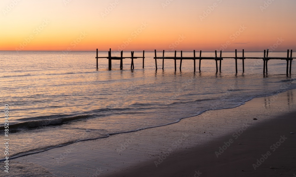Fototapeta premium Sunset over a weathered pier