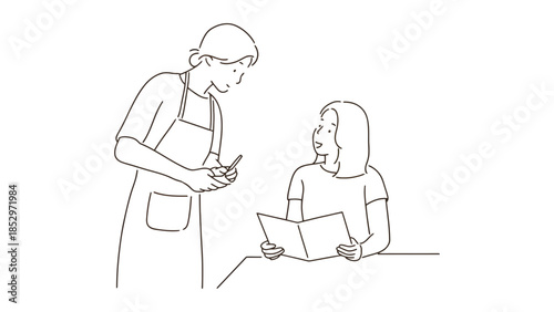 A server takes an order from a customer at a restaurant table.