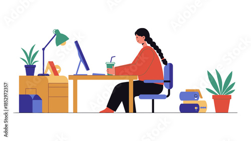 A person sits at a desk and works on a computer with a drink.