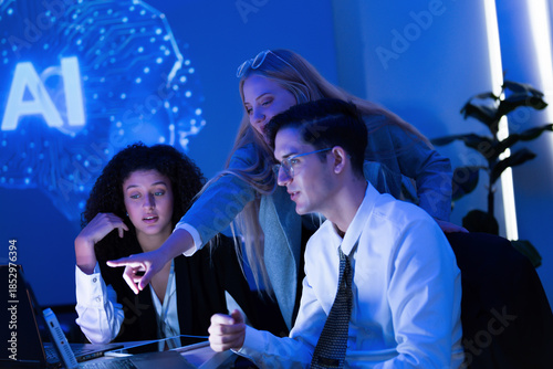 Group of professionals collaborating in a modern office on artificial intelligence project during evening